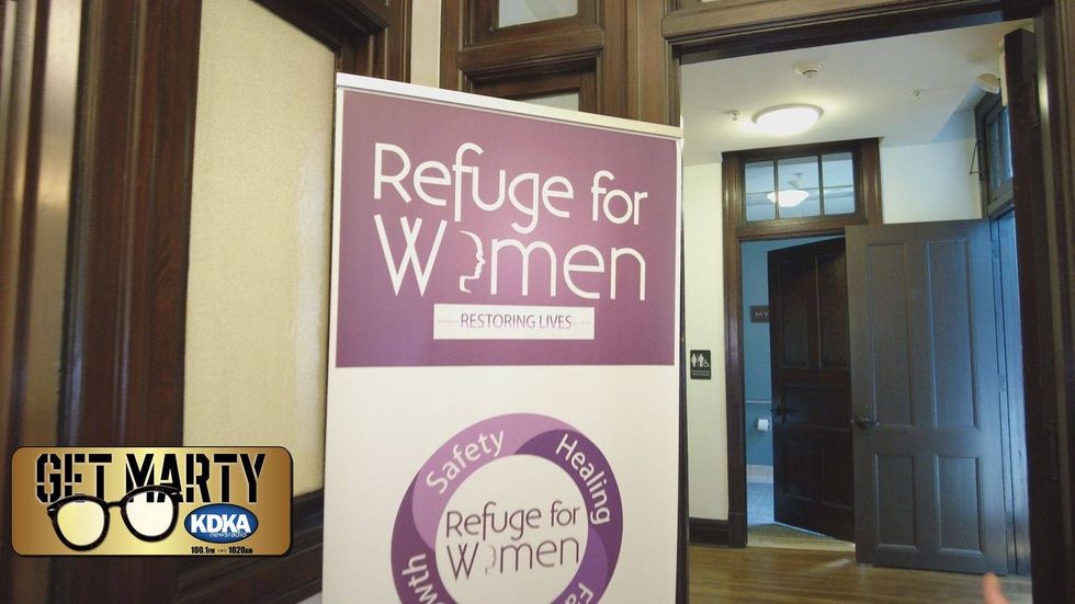 Photo of a stand-up banner saying "Refuge for Women"