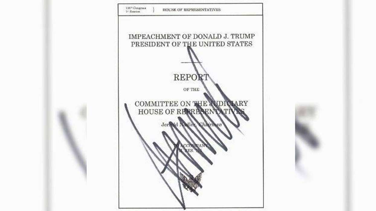 Photo of impeachment report authored by House Democrats, with the president’s signature on the cover page.