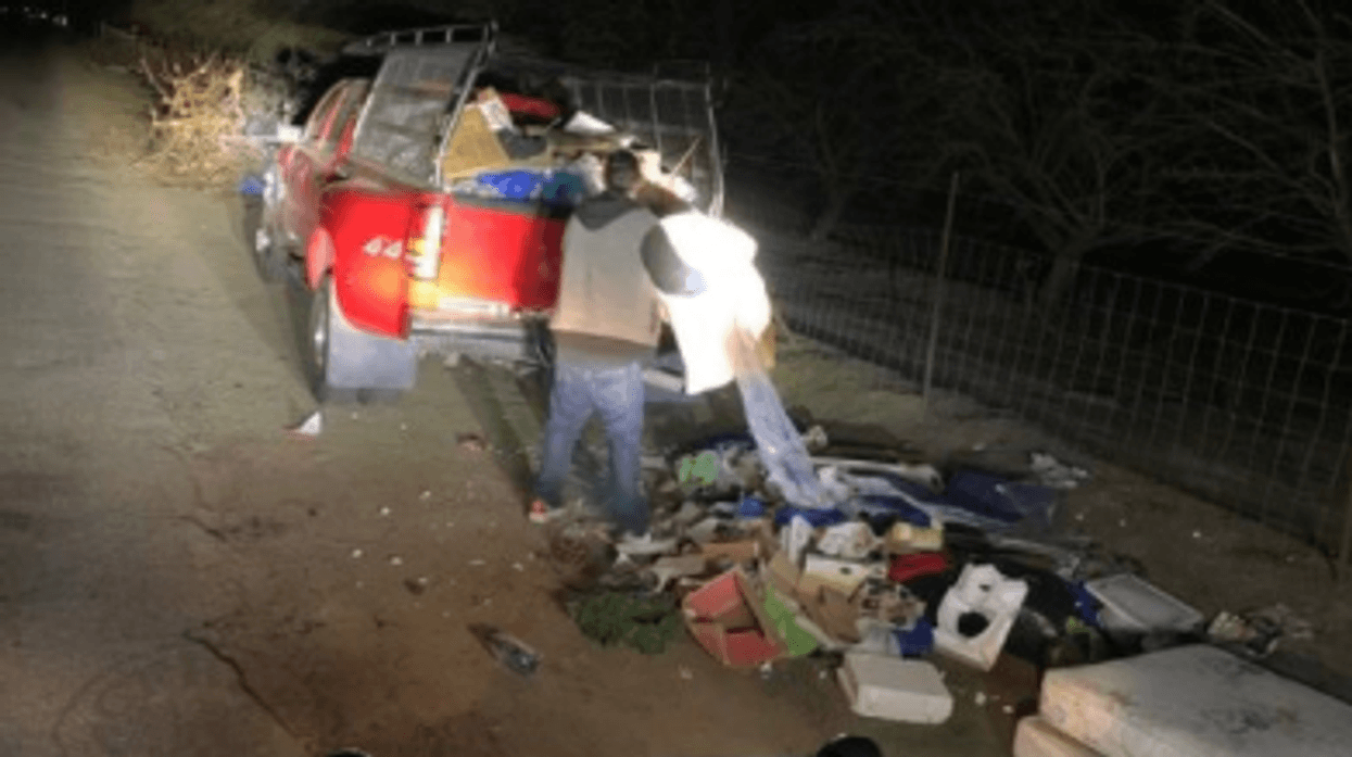 Photo of man dumping trash