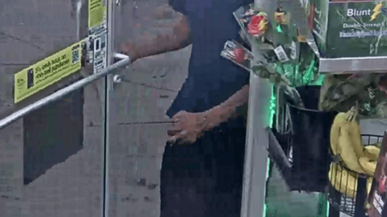 Photo of suspect in Detroit breaking and entering. Black male wearing a black or blue ball cap with a yellow brim, blue t-shirt and dark-colored shorts with white and gray Nike tennis shoes.