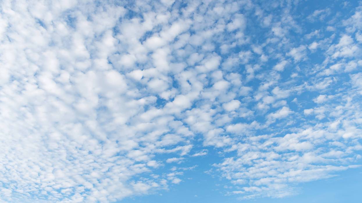 Photo of the sky with light cloud cover. On the summer solstice, St. Louis is experiencing its first orange-level air quality day.