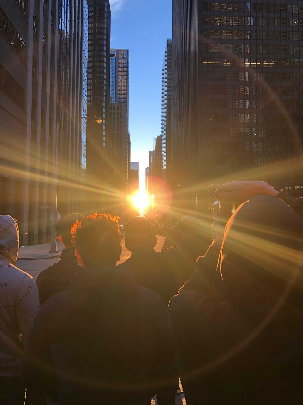 Photographers - professionals and amateurs - were seen all over downtown between 6 p.m. and 7 p.m. on Saturday to try and get the perfect shot of a rare phenomenon - the dramatic alignment of the setting sun and Chicago