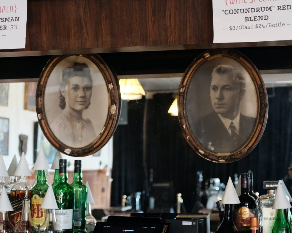 Photos of Yvonne and Robert Devos hang above the bar at the Cadieux Cafe in Detroit