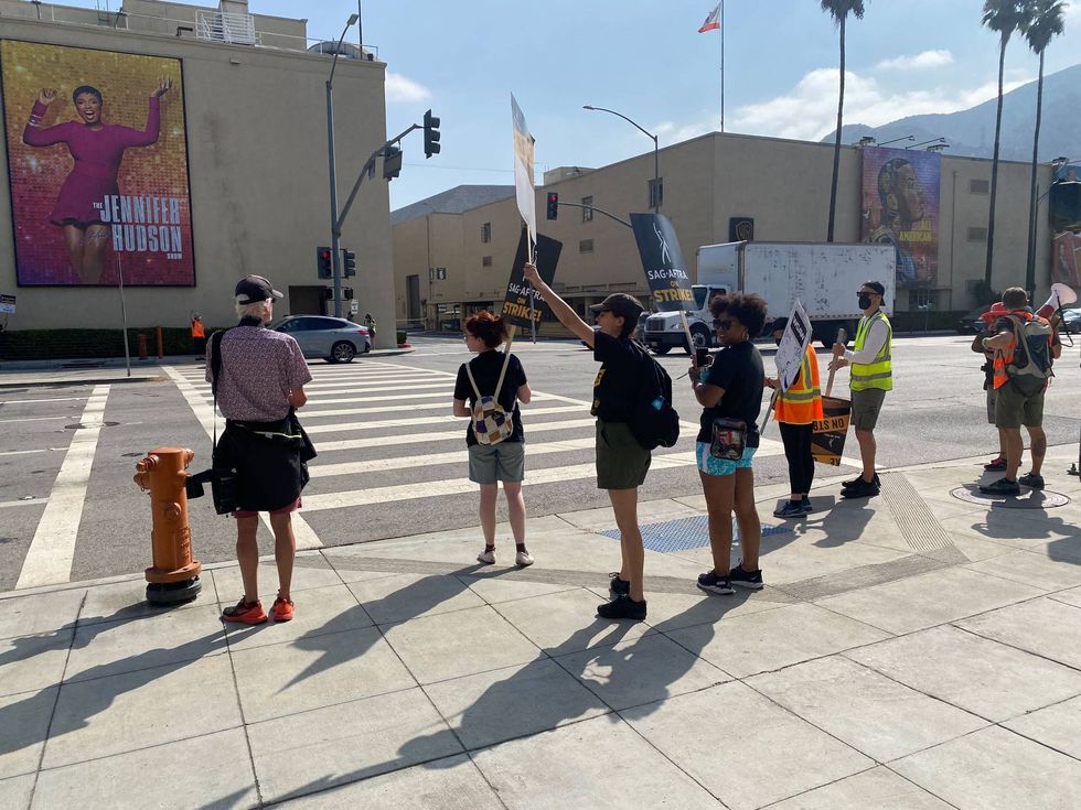 Picketers outside Warner Bros. Studios in Burbank. The three girls in the black shirts, (from L to R) Conner, Devin, and Julyza, chant, \Jen
