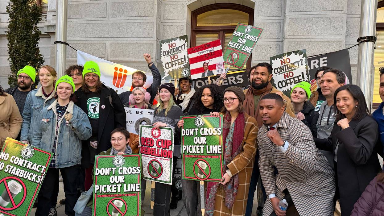 Picketing baristas pose for a photo outside City Hall on Thursday, Nov. 13.