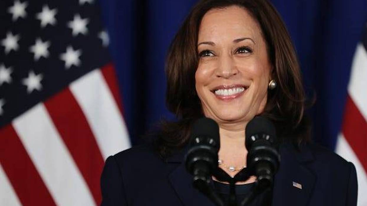 Picture of Vice President Kamala Harris at a podium in front of several American flags.