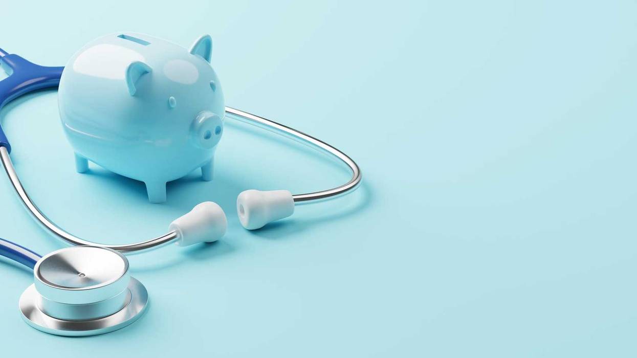 Piggy bank and stethoscope representing health care costs.