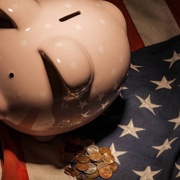 Piggy Bank on Flag with Coins – Fragile U.S. Economy