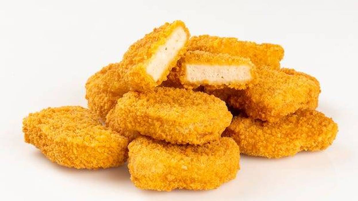 Pile of chicken nuggets against a white background