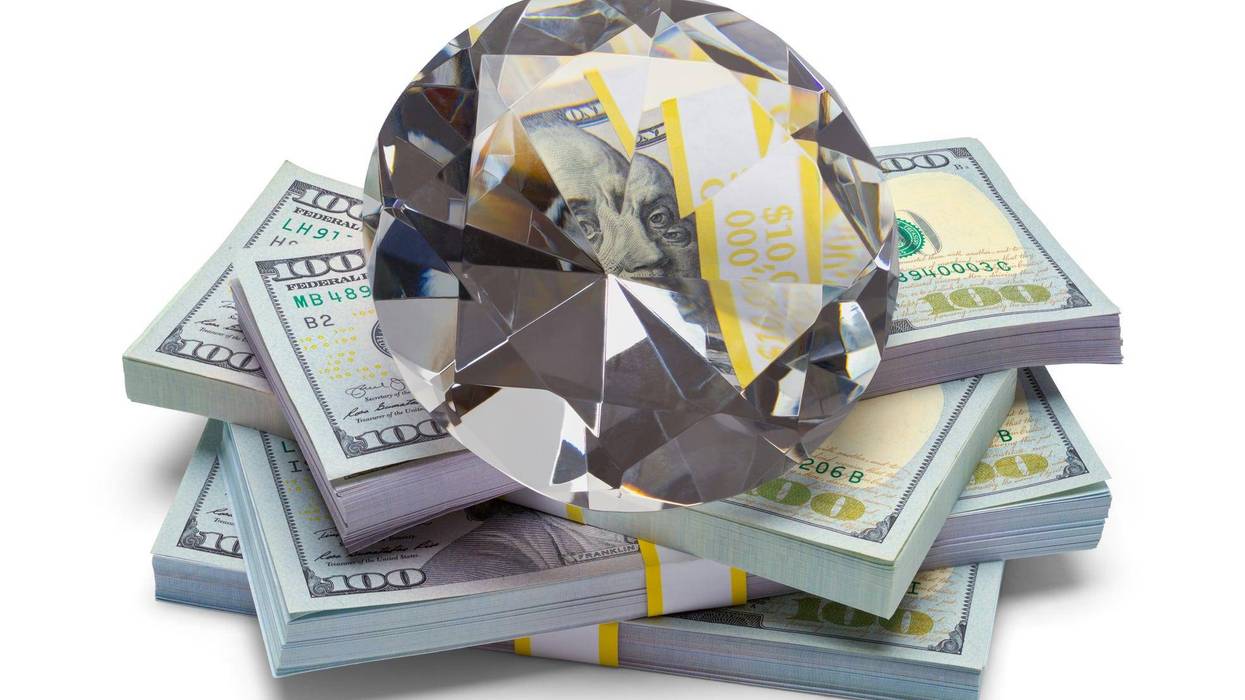Pile of Money with a Large Diamond Isolated on a White Background.