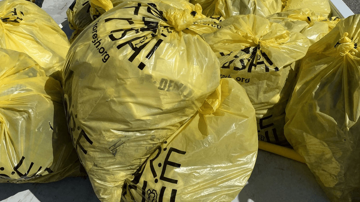 Piles of bags of roadside trash from a Charlie Brennan-organized clean-up