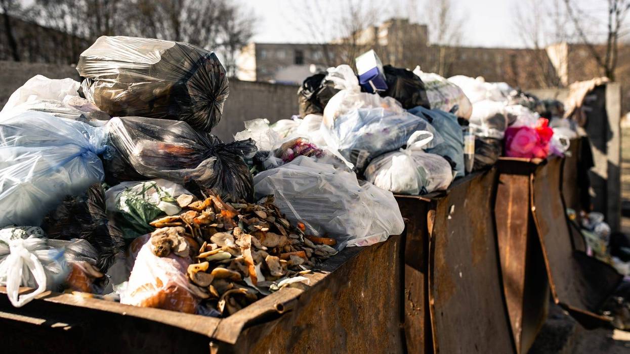 piles of trash in dumpsters