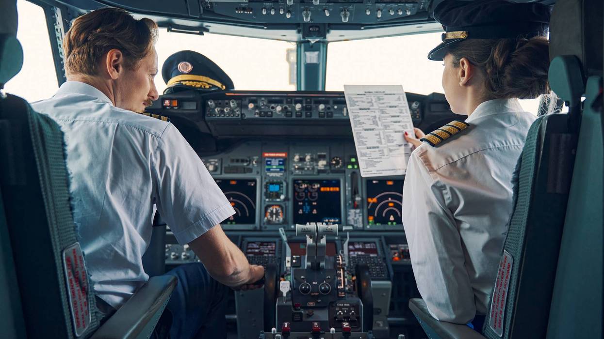 Pilot and female first officer seated in the flight deck