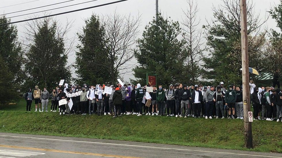Pine-Richland High School students, players and parents protest firing of football coach Eric Kasperowicz and his staff outside of the school on Friday, April 16, 2021