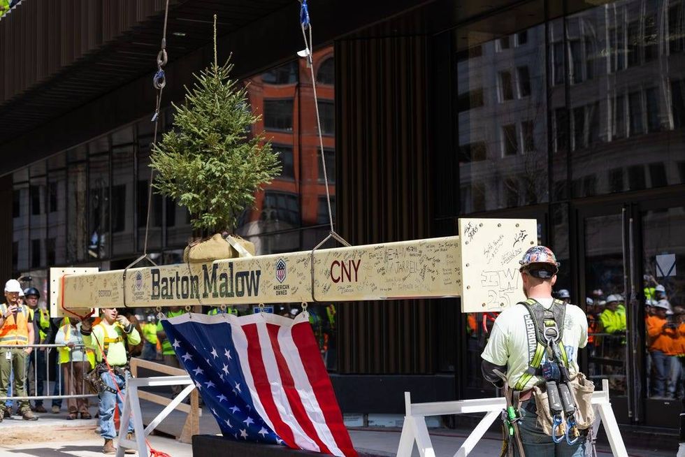 Pine tree and U.S. flag on final steel beam of Hudson