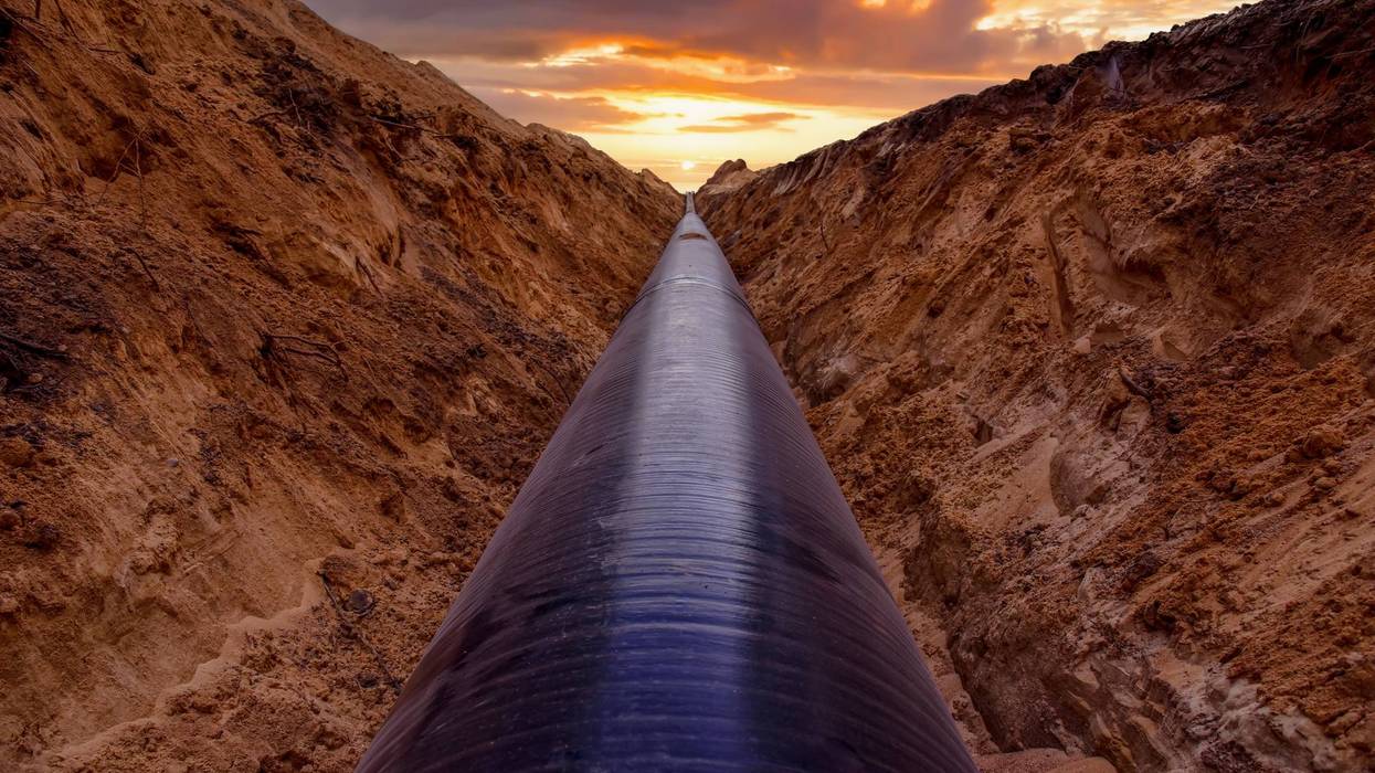 Pipeline Construction. Natural Gas Pipeline trench in ground on sunset. LNG, LPG.