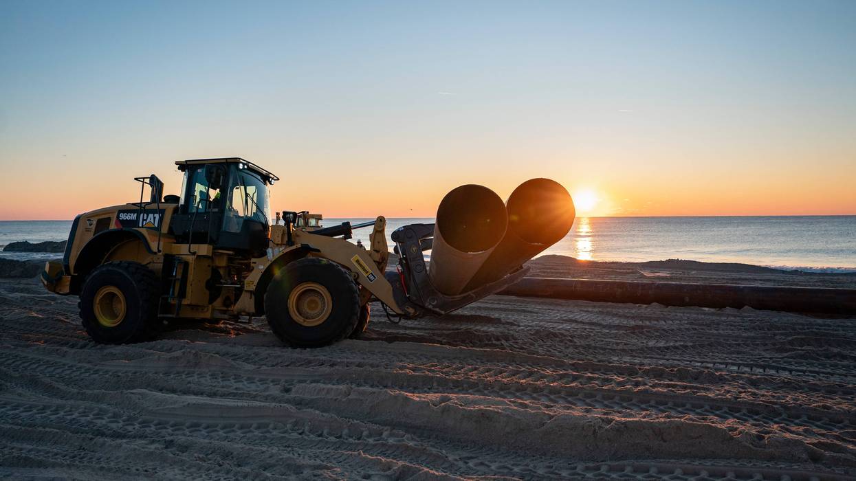 Pipes are moved onto the beach during a nourishment project on Jan. 20, 2024, in Wrightsville Beach, North Carolina.