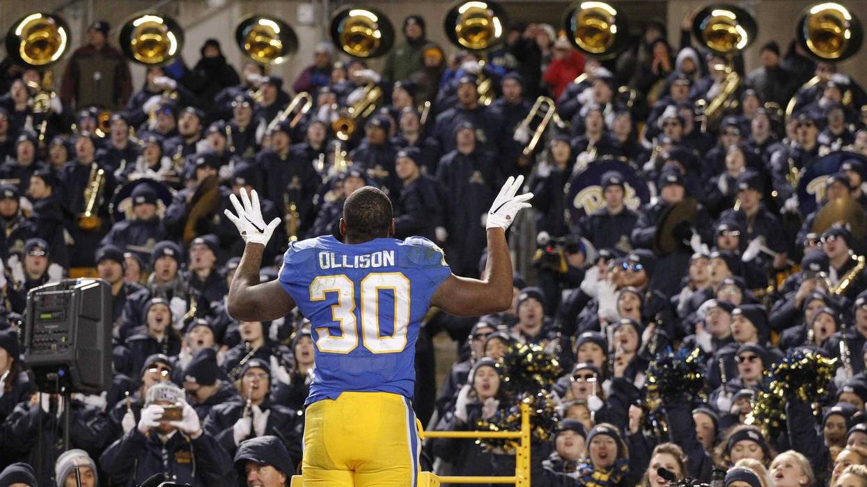 Pitt player directing band at Heinz Field