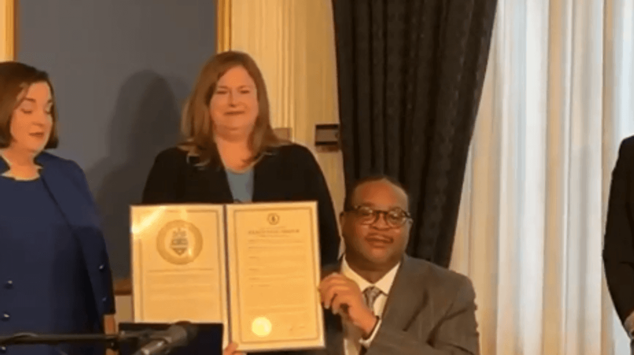 Pittsburgh Mayor Ed Gainey holds up executive order
