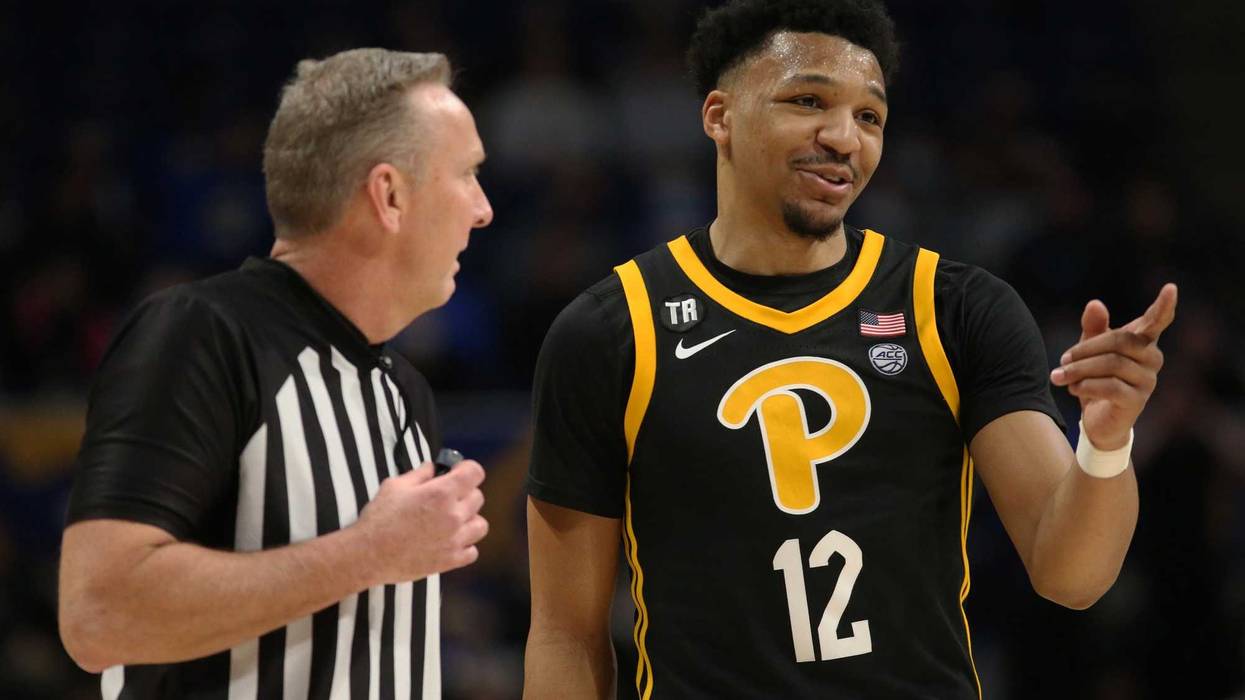 Pittsburgh Panthers guard Ithiel Horton (12) talks with referee Jamie Luckie (left)