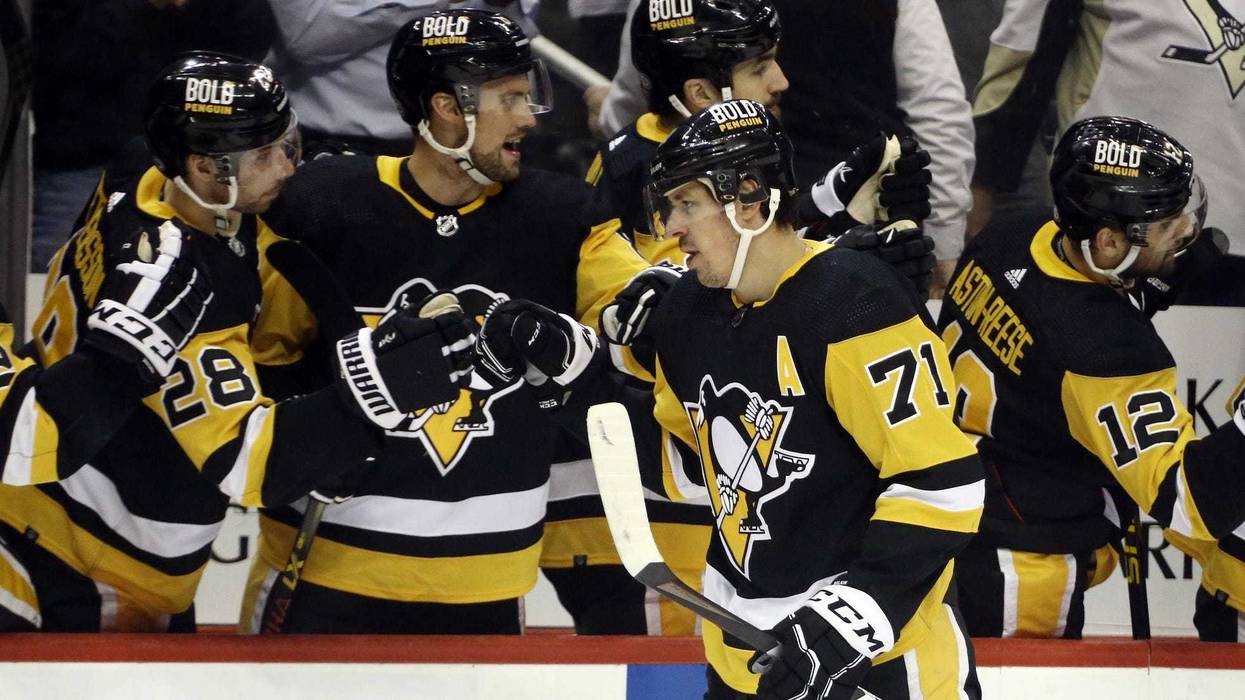 Pittsburgh Penguins center Evgeni Malkin (71) celebrates with the Pens bench after scoring a power play goal