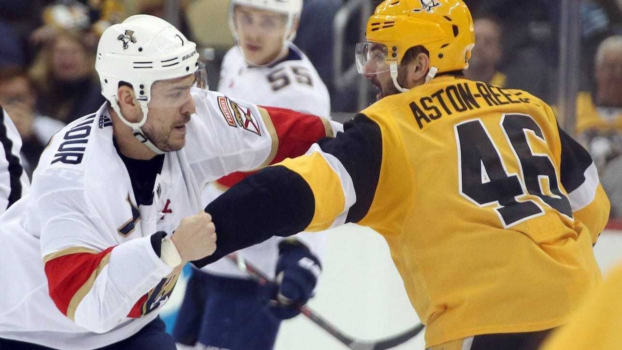 Pittsburgh Penguins center Zach Aston-Reese (46) and Florida Panthers center Colton Sceviour (7) fight during the third period at PPG PAINTS Arena. The Penguins won 5-1.