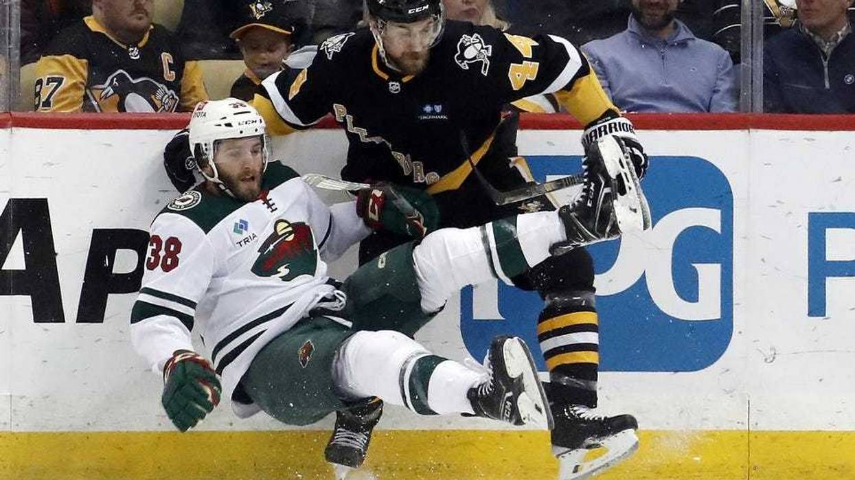 Pittsburgh Penguins defenseman Jan Rutta (44) checks Minnesota Wild right wing Ryan Hartman (38) during the second period at PPG Paints Arena. Pittsburgh won 4-1.