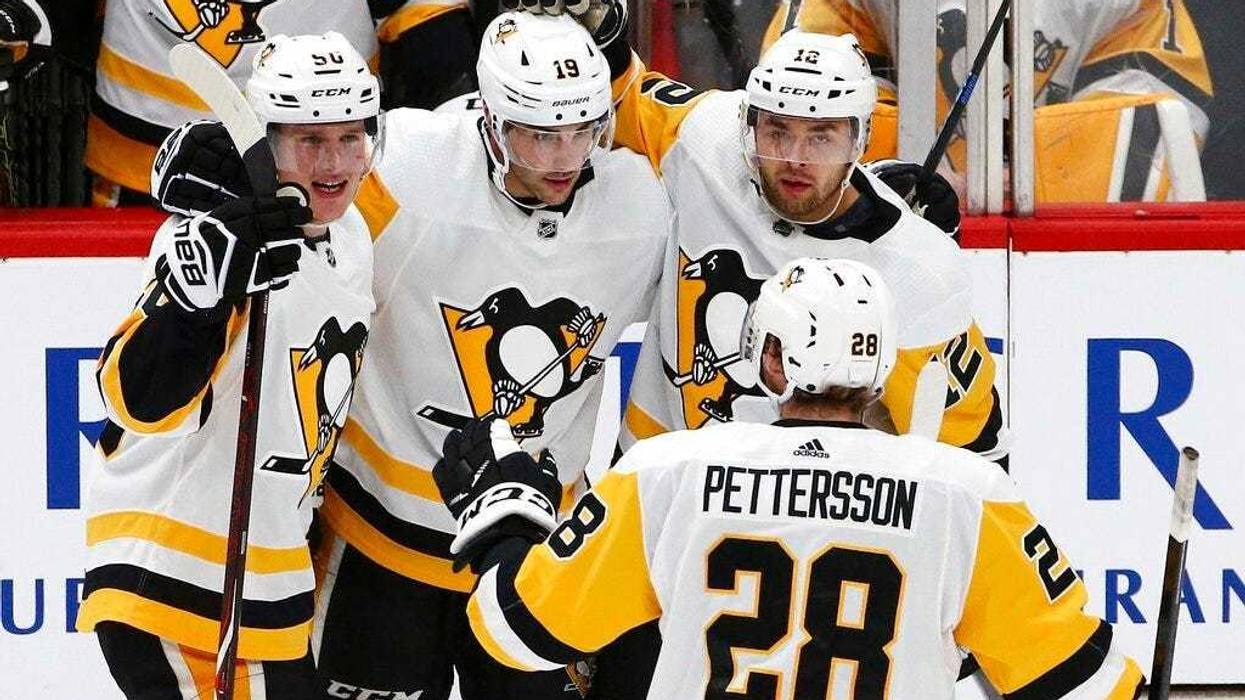 Pittsburgh Penguins defenseman Juuso Riikola (50) celebrates his goal against the Arizona Coyotes with center Derick Brassard (19), center Dominik Simon (12) and defenseman Marcus Pettersson (28) during the second period of an NHL hockey game Friday, Jan.