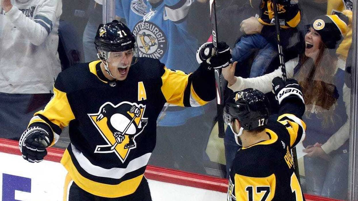 Pittsburgh Penguins' Evgeni Malkin (71) celebrates with Pittsburgh Penguins' Bryan Rust (17) after scoring against the Ottawa Senators during the first period of an NHL hockey game, Monday, Dec. 30, 2019, in Pittsburgh.