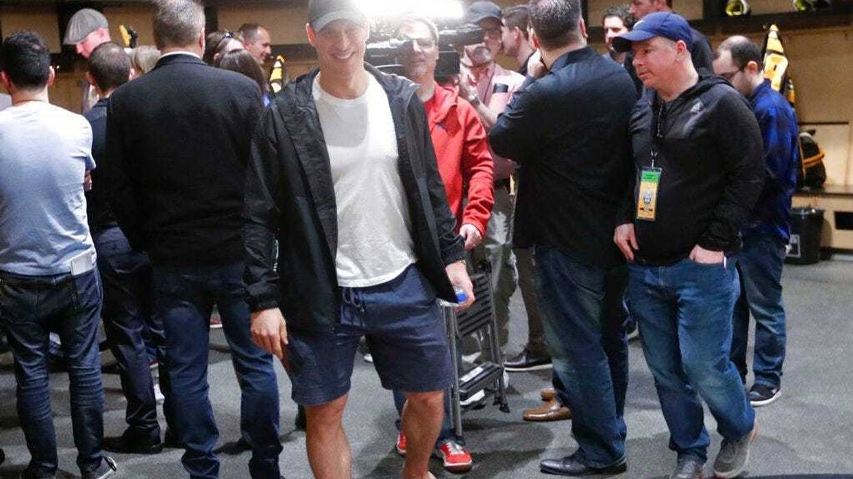 Pittsburgh Penguins' Sidney Crosby walks from reporters after talking with them in the practice facility locker room before leaving for the off season two days after being swept by the New York Islanders in the first round of the NHL hockey playoffs, Thur