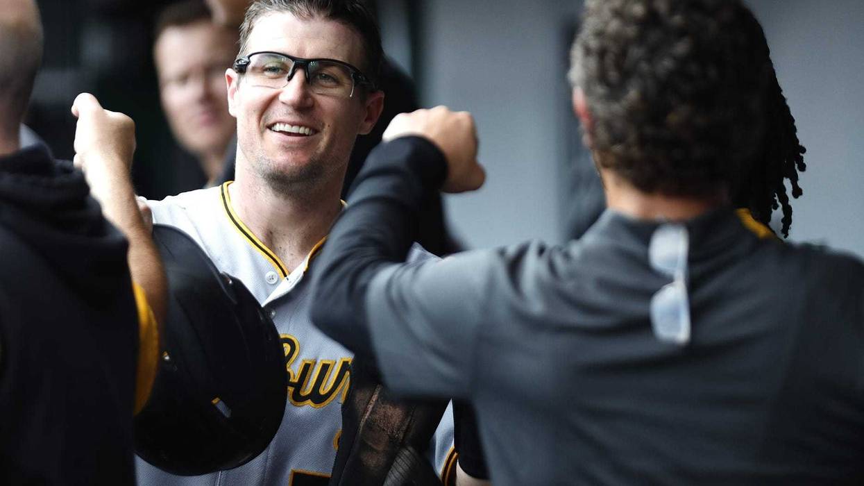 Pittsburgh Pirates catcher Tyler Heineman (54) reacts in the dugout after scoring against the Cincinnati Reds