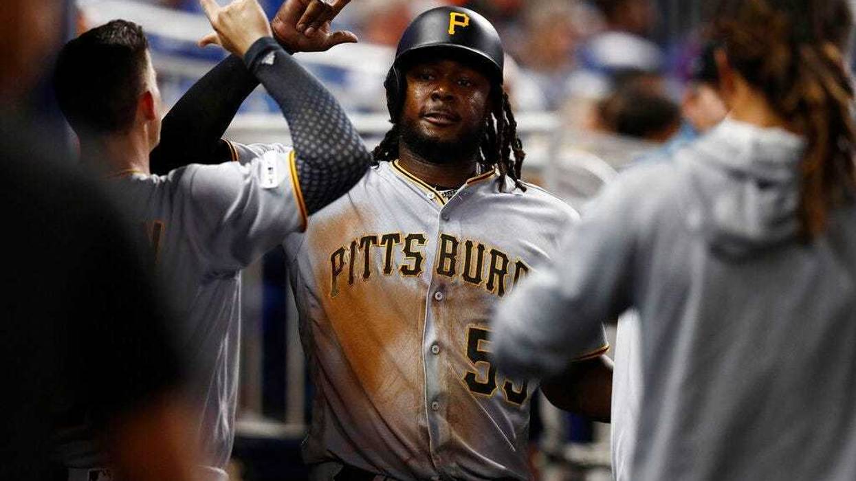 Pittsburgh Pirates' Josh Bell (55) celebrates in the dugout after scoring during the fifth inning of a baseball game against the Miami Marlins, Friday, June 14, 2019, in Miami.