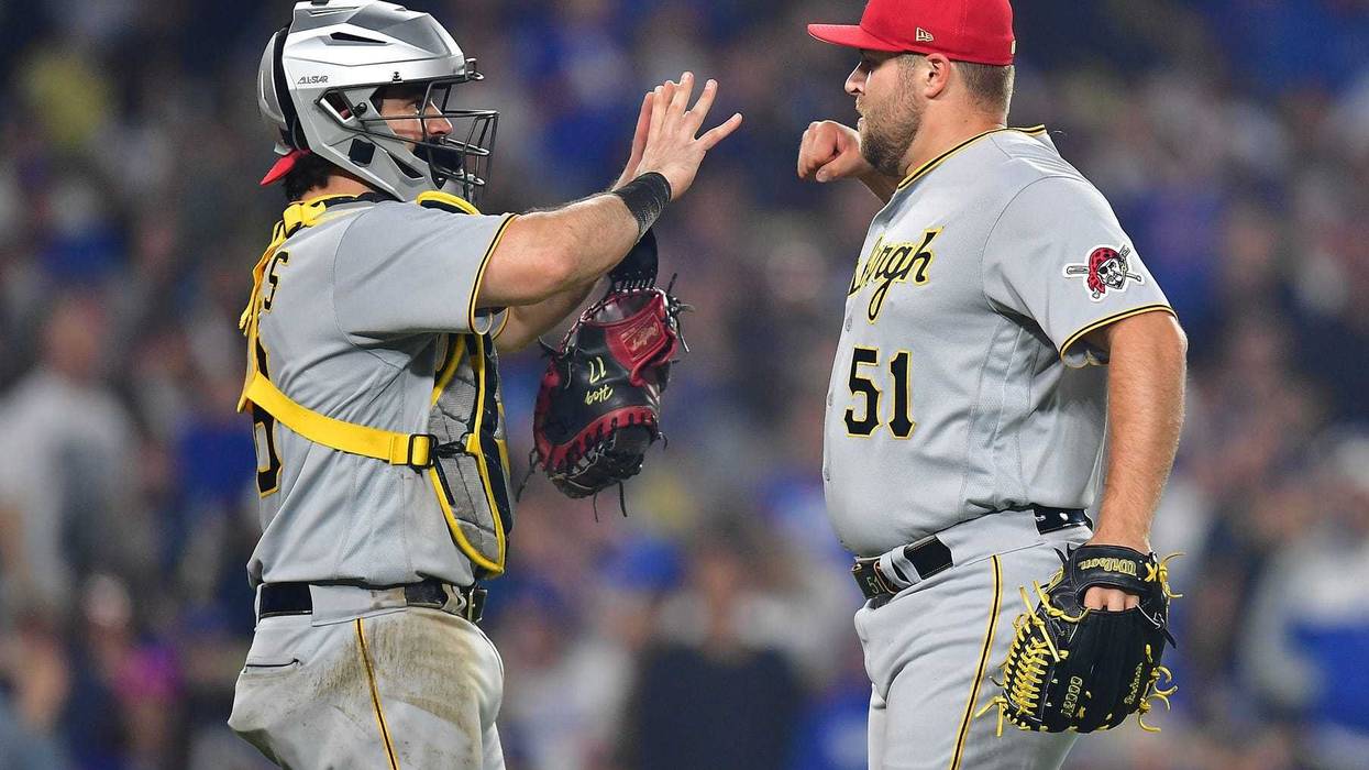Pittsburgh Pirates relief pitcher David Bednar (51) and catcher Austin Hedges (18) celebrate the victory