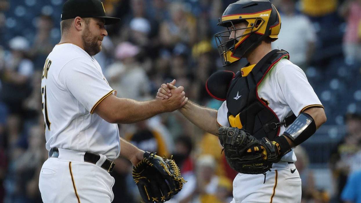 Pittsburgh Pirates relief pitcher David Bednar (51) and catcher Jason Delay (55) shake hands after defeating the Miami Marlins at PNC Park.