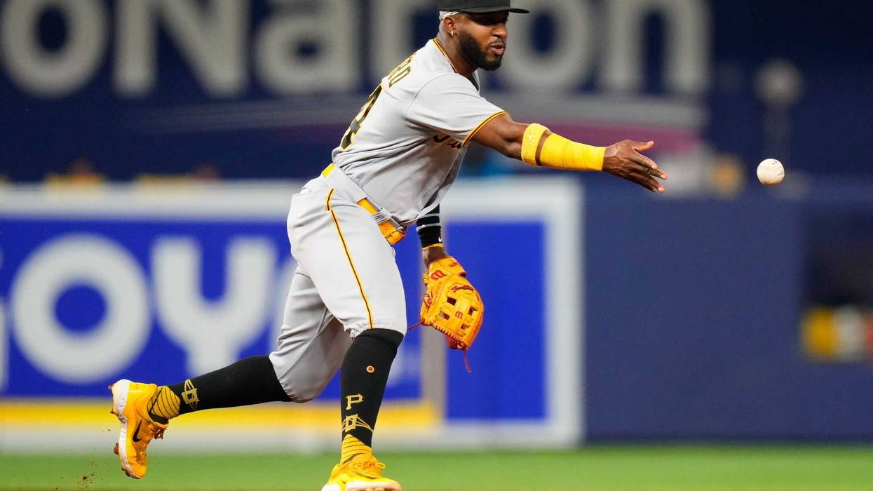 Pittsburgh Pirates shortstop Rodolfo Castro (14) throws the ball into second base
