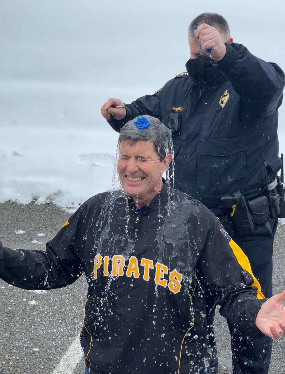 Pittsburgh Police Chief Scott Schubert pops balloon full of cold water over Rick Dayton