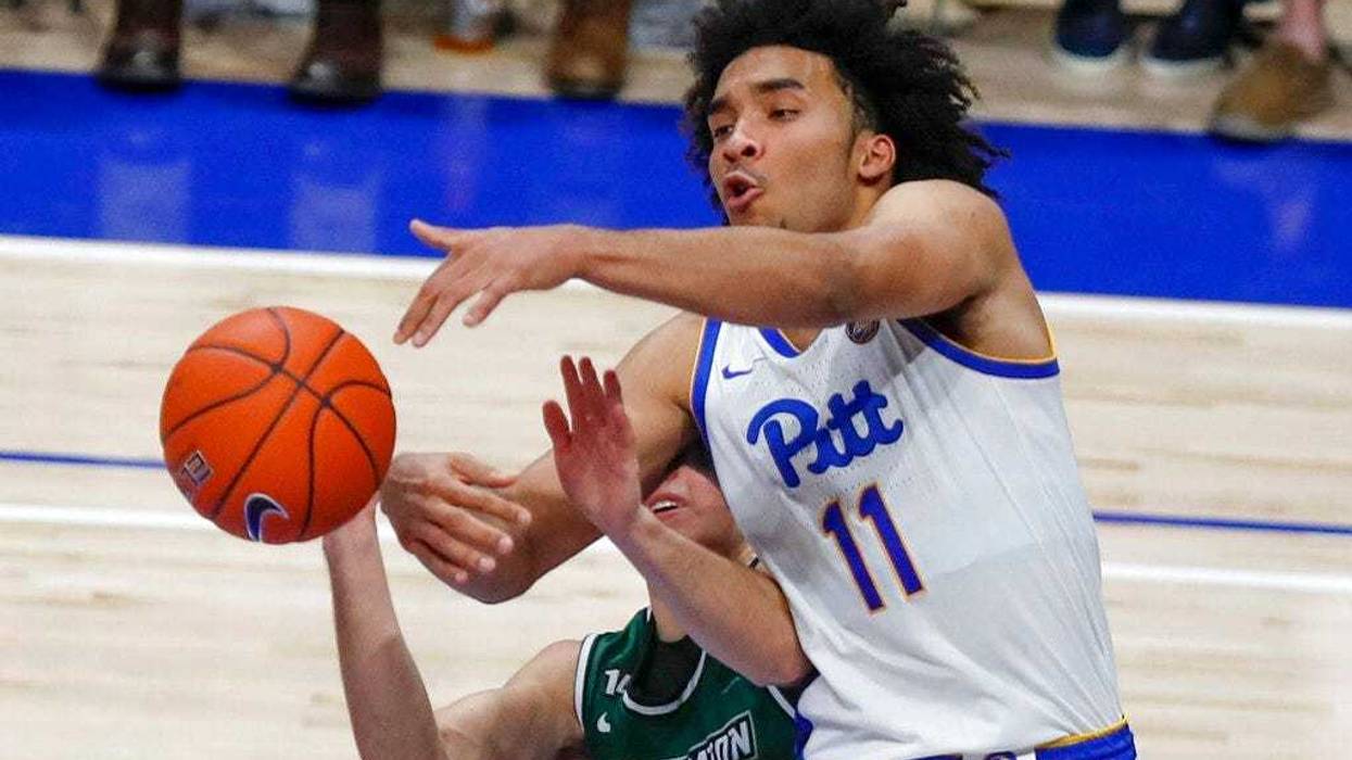 Pittsburgh's Justin Champagnie (11) tries to catch a pass as Binghamton's Dan Petcash defends during the second half of an NCAA college basketball game Friday, Dec. 20, 2019, in Pittsburgh. Pittsburgh won 79-53.