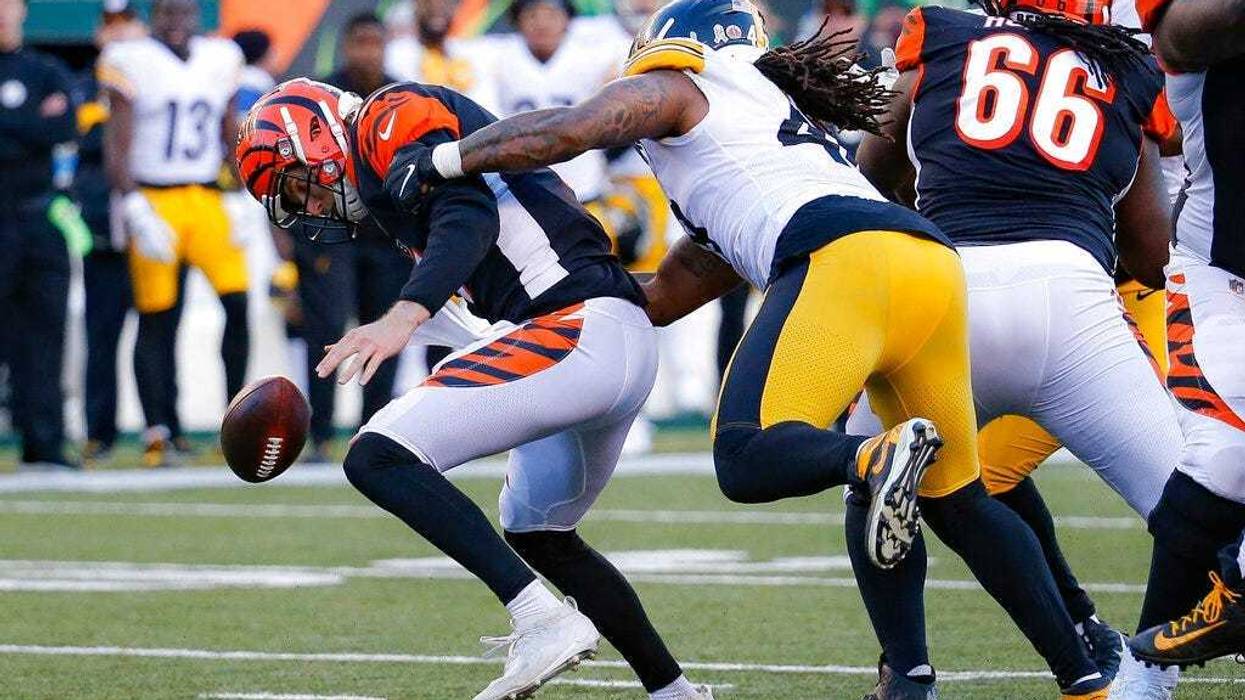Pittsburgh Steelers outside linebacker Bud Dupree, right, forces a fumble the fumble off Cincinnati Bengals quarterback Ryan Finley, left, before recovering the ball for a turnover during the second half an NFL football game, Sunday, Nov. 24, 2019, in Cin
