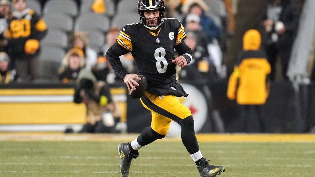 Pittsburgh Steelers quarterback Aaron Rodgers (8) runs with the ball during the first half of an NFL football game against the Baltimore Ravens, Sunday, Jan. 4, 2026, in Pittsburgh.
