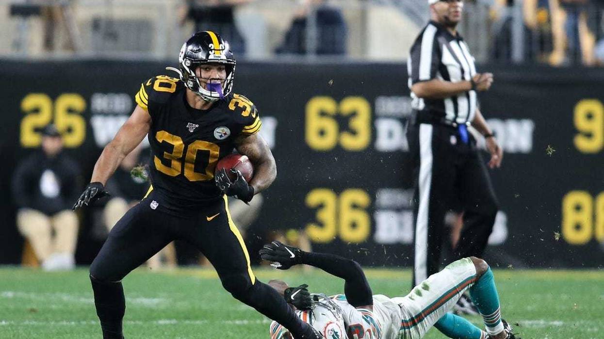 Pittsburgh Steelers running back James Conner (30) carries the ball past Miami Dolphins cornerback Jomal Wiltz (33) during the second quarter at Heinz Field.