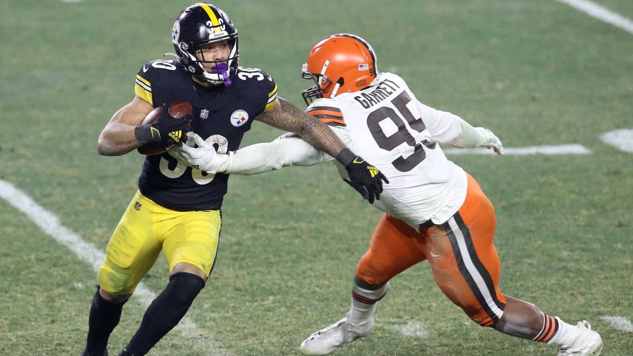Pittsburgh Steelers running back James Conner (30) tries to get away from Cleveland Browns defensive end Myles Garrett (95) in the fourth quarter of an AFC Wild Card playoff game at Heinz Field.
