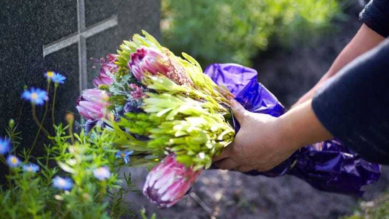 placing flowers on a grave