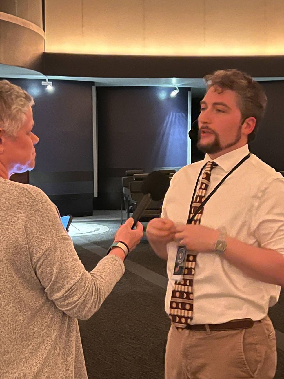 Planetarium Manager Will Snyder talking with KMOX's Megan Lynch