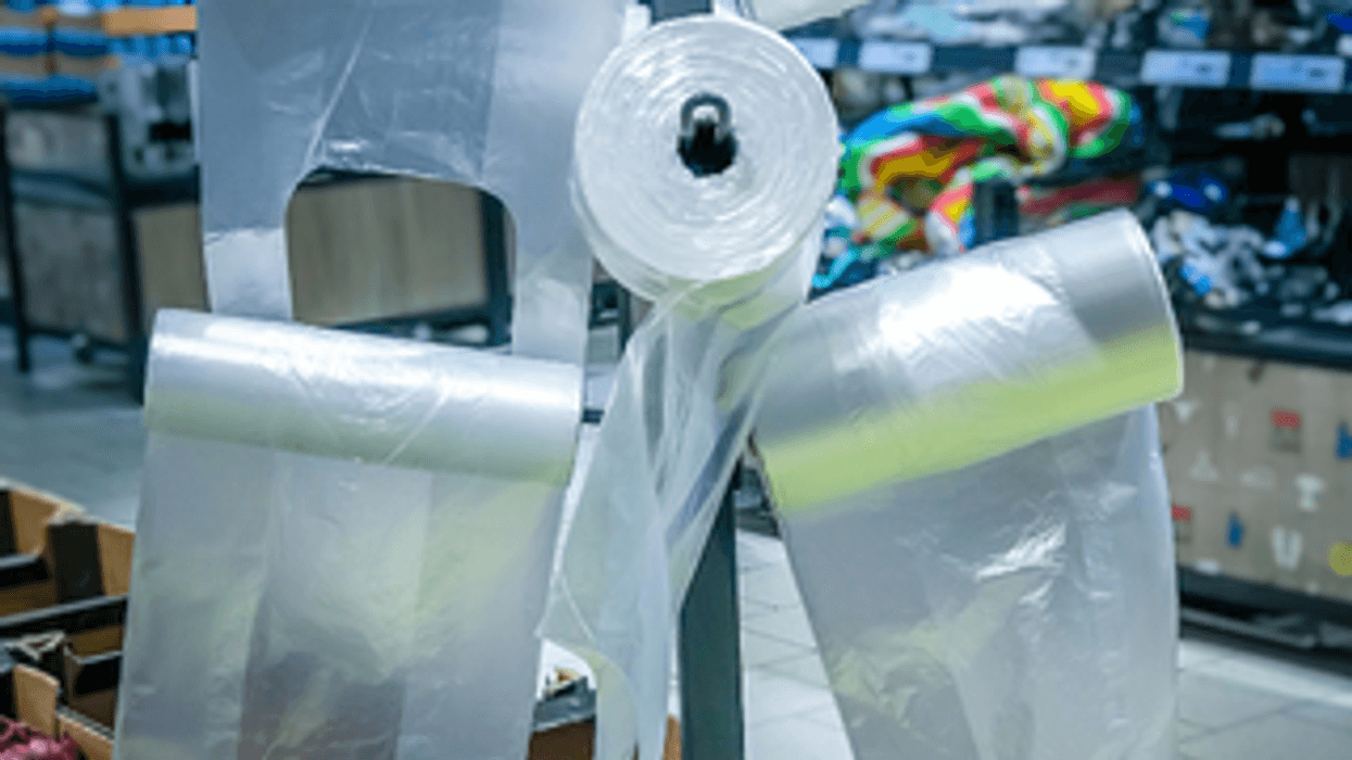 Plastic cellophane bags hanging on the stand in the supermarket fruits - vegetables department.
