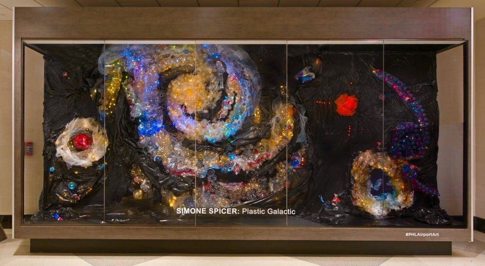 "Plastic Galactic," on display at Philadelphia International Airport is made from more than 1,000 transparent bottles, color-changing LEDs, and black plastic bags.