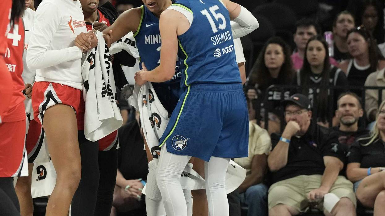 Players from the Las Vegas Aces and Minnesota Lynx surround Lynx forward Napheesa Collier (24) after she does down with an injury in the third quarter of their game at Michelob Ultra Arena.