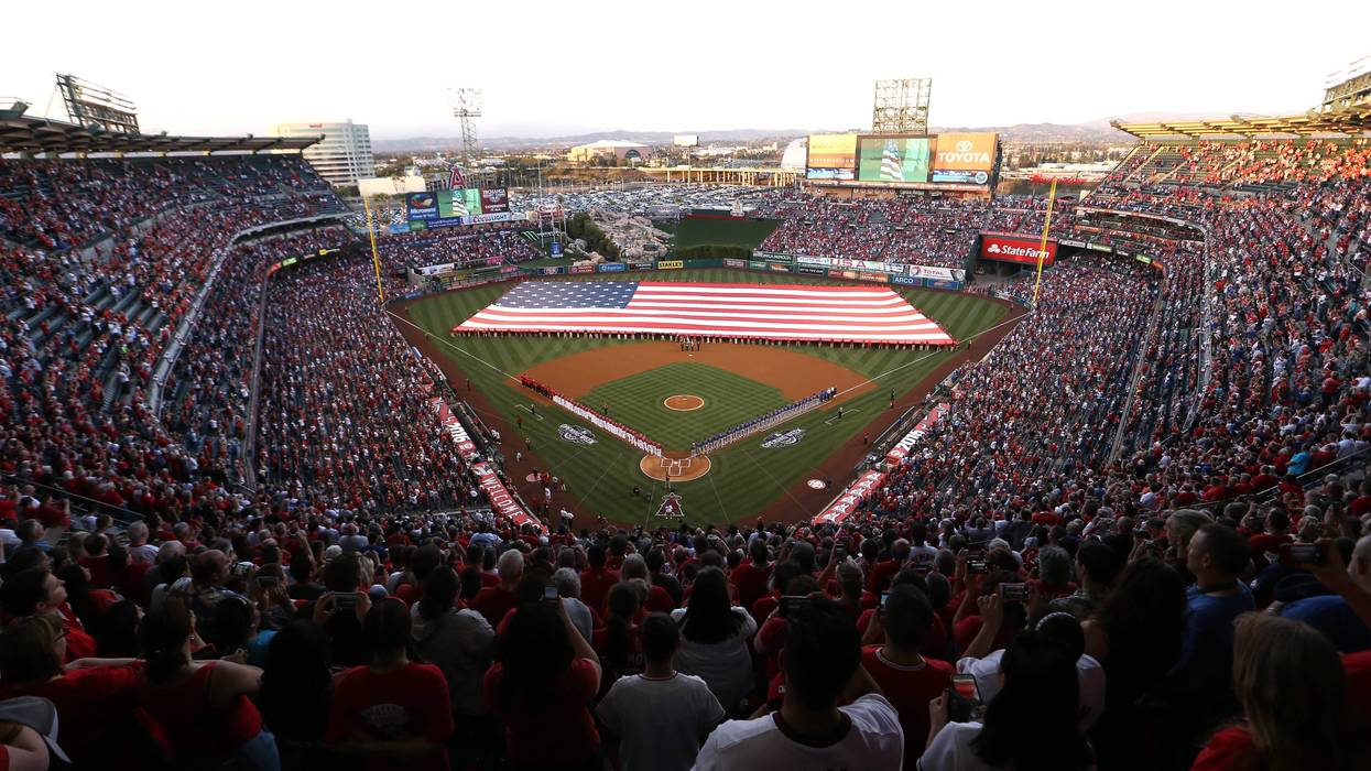 Players line the field during pre-game festivities on Opening Day before a baseball game between the Los Angeles Angels and Chicago Cubs at Angel Stadium of Anaheim on April 4, 2016 in Anaheim, California.
