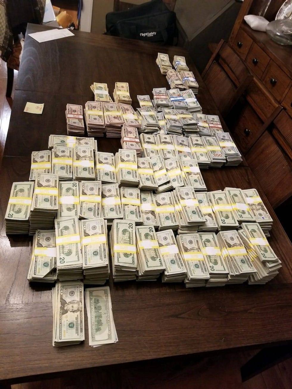 Police allegedly found almost $900,000 and ledgers detailing an illegal operation selling fake COVID vaccination cards when they searched Julie DeVuono