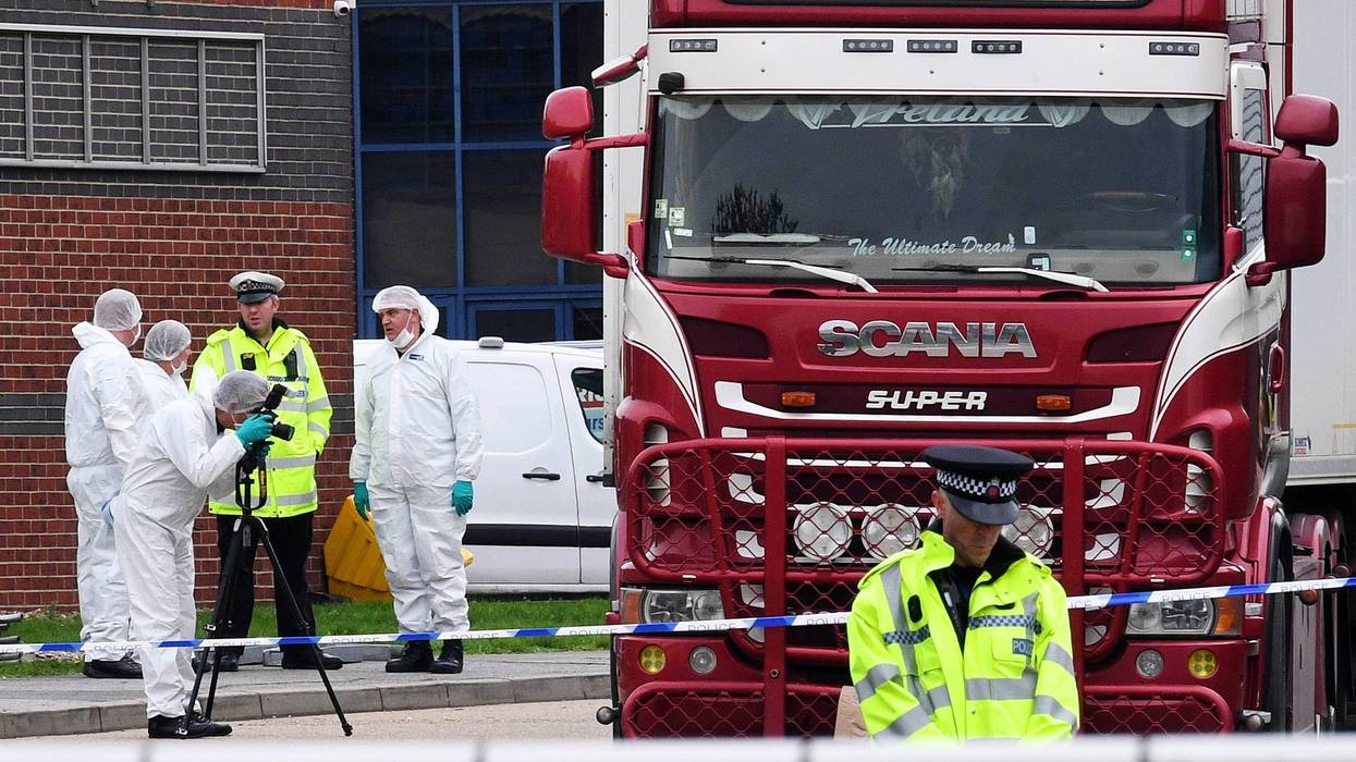Police and forensic officers investigate a lorry in which 39 bodies were discovered in the trailer, as they prepare move the vehicle from the site on October 23, 2019 in Thurrock, England.