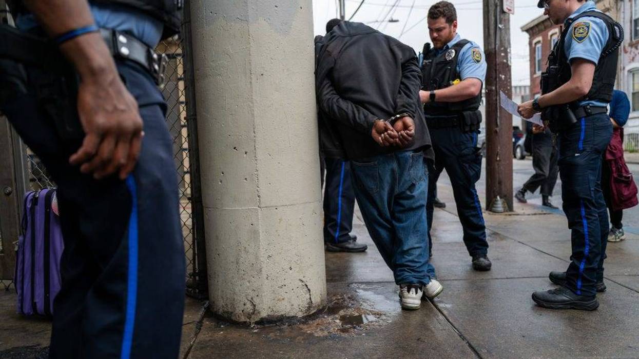 Police arrest a man as the city of Philadelphia begins a long anticipated clearing of an encampment of drug users in active addiction in the Kensington neighborhood on May 8, 2024.